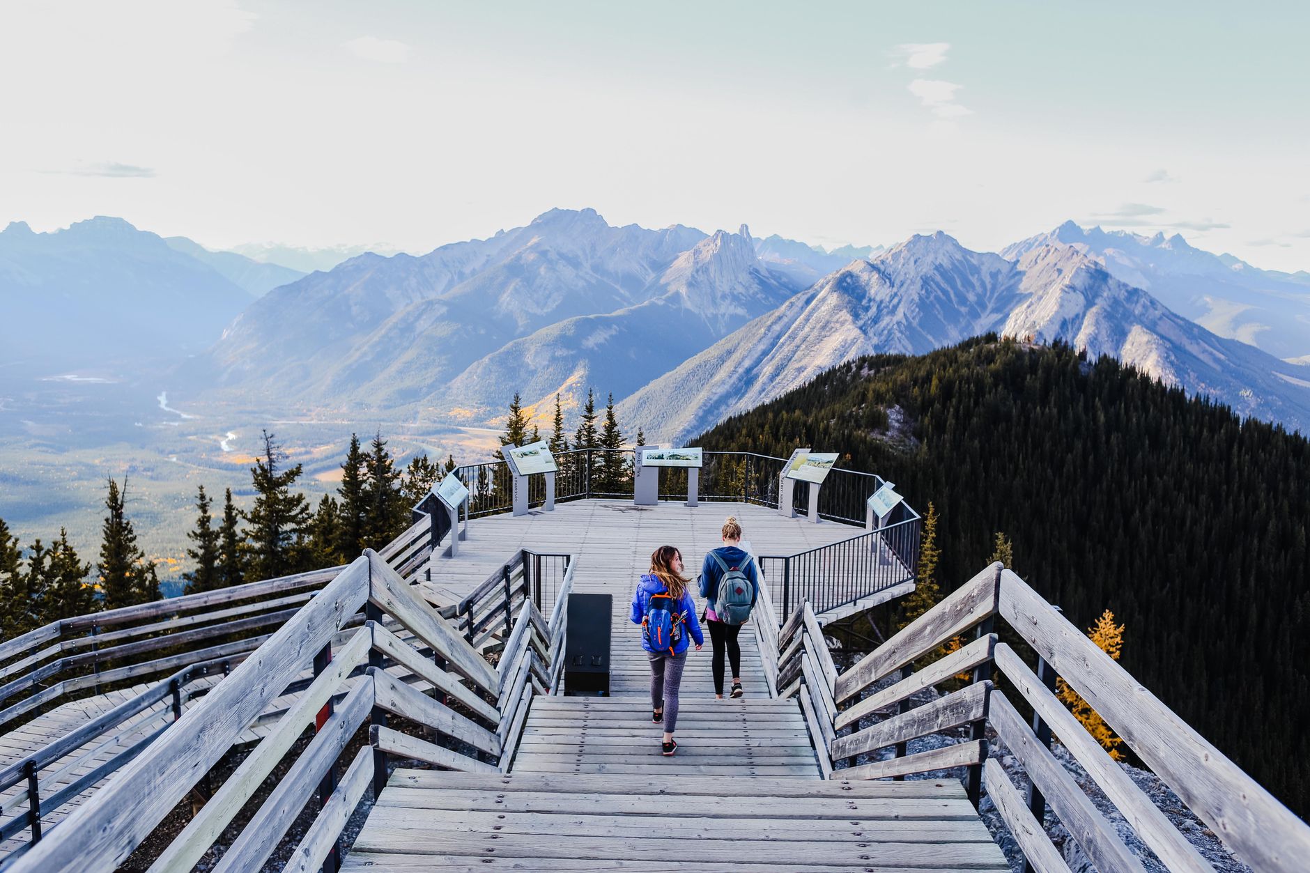 Two hikers gazing over deep glacial lakes of New Zealand